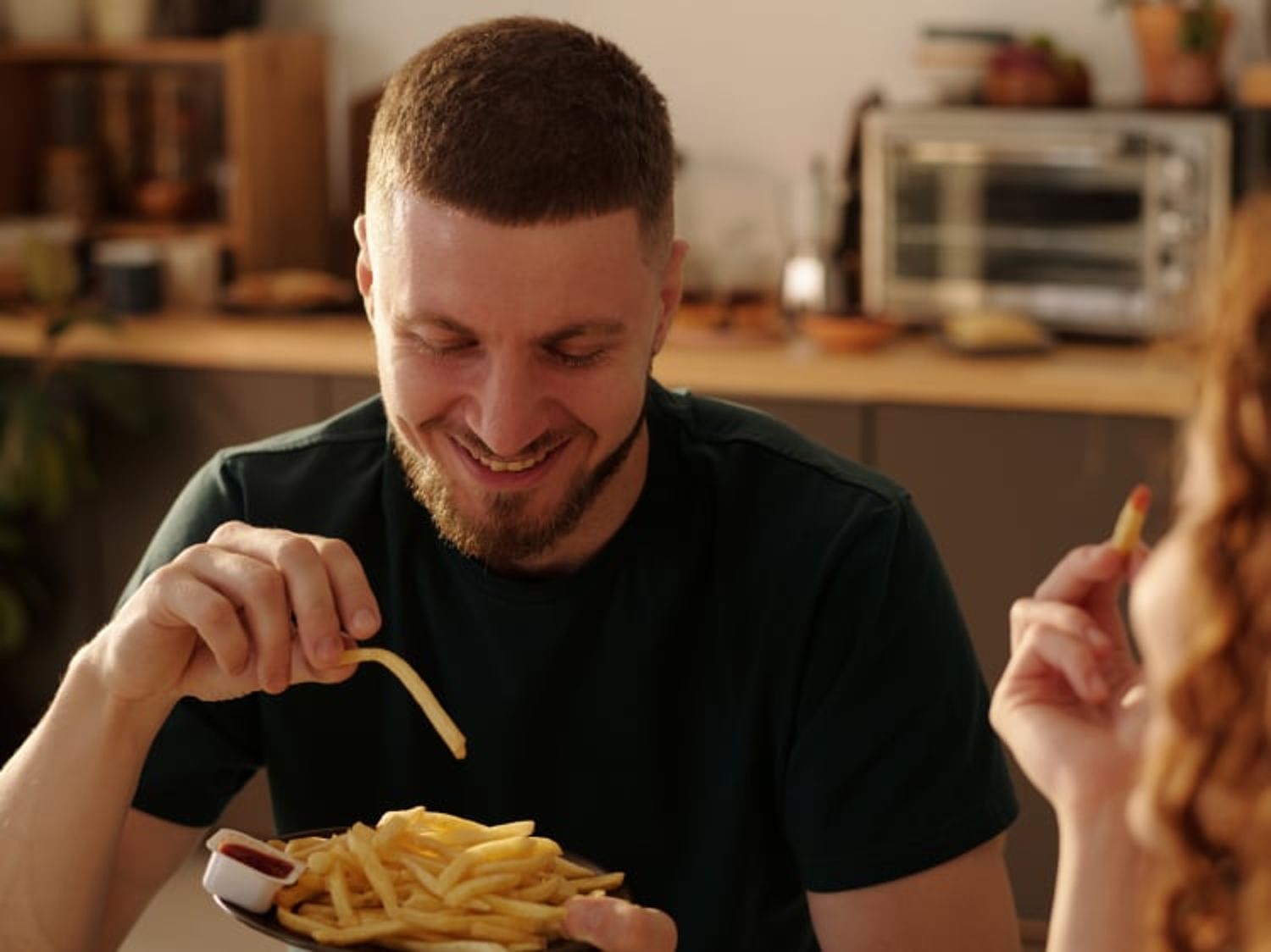 Image shows a person eating McDonald's fries